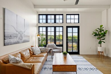 Living room featuring concrete flooring and ceiling fan