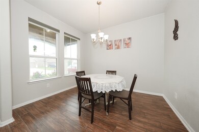 This dining area features wood-style flooring, a r