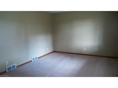 Living room has newly installed plush carpet.  Thi
