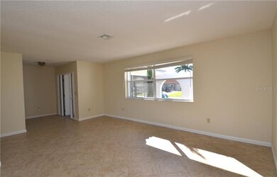 Screened front entry leads into formal living and 