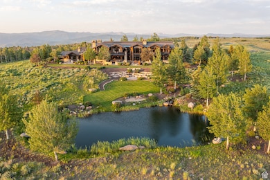 Aerial view of property and surrounding area featuring a water and mountain view