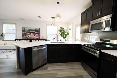 Kitchen with stainless steel appliances, a penins