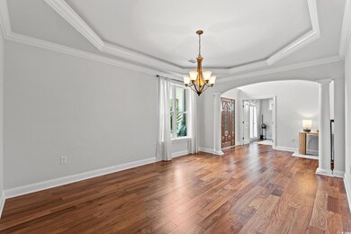 Empty room with ornamental molding, a raised ceili
