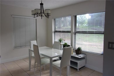 Dining room featuring a chandelier, light tile pat