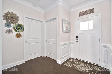 Step into your front entry that has very detailed, picture window, chair rail molding.