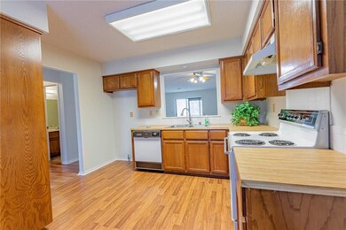 The bright and spacious kitchen features a pass through to the dining room, for convenience and lot of light.