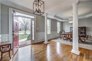 Double crown moldings, wainscoting and a tray ceil