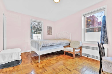 Bedroom with radiator and baseboards