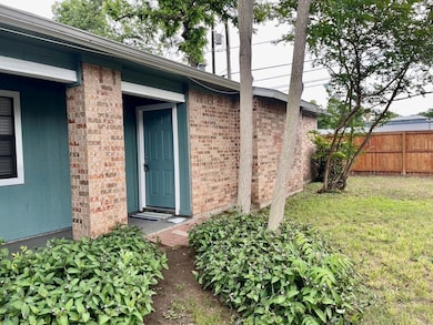 Entrance to property featuring a yard, fence, and