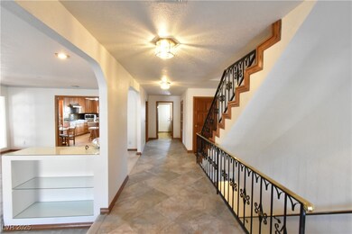 downstairs hall & staircases with wrought iron & b