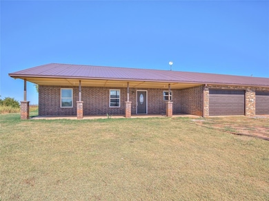 Ranch-style house with a garage and a front yard