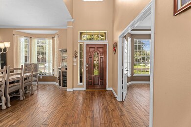 Welcoming entryway with a rich wooden front door a