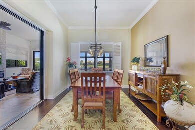 Dining room featuring ornamental molding, a chandelier, and dark wood finished floors