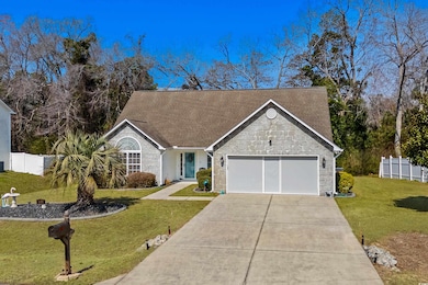 View of front of house featuring fence, a front ya