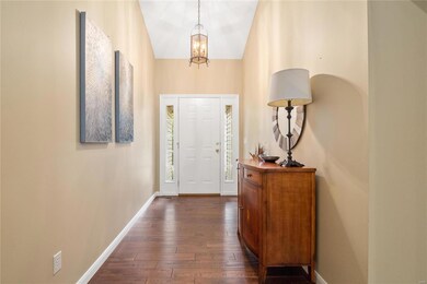 Entry foyer with vaulted ceiling & hardwood floori