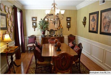 Elegant dining room with hardwood floors, decorati