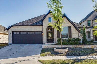 French country home with a garage, brick siding, c