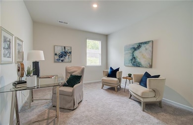 Living area featuring carpet floors and baseboards