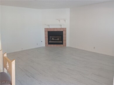 Unfurnished living room featuring a tiled fireplace