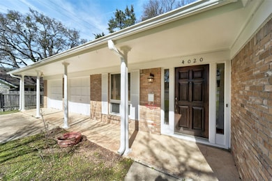 Property entrance with brick siding, a porch, con