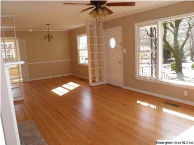Gleaming hardwood floors and lots of windows provi