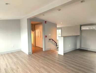 The living room with the entrance stairs and entry