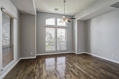Bright and spacious living room with rich hardwood