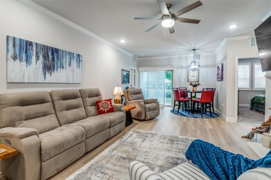 Living room featuring ceiling fan, ornamental mold