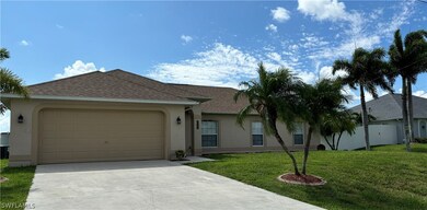 Single story home featuring a front yard and a garage