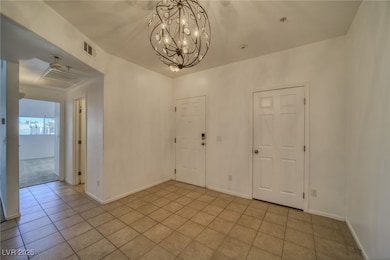 Unfurnished dining area featuring tile patterned floors and a chandelier