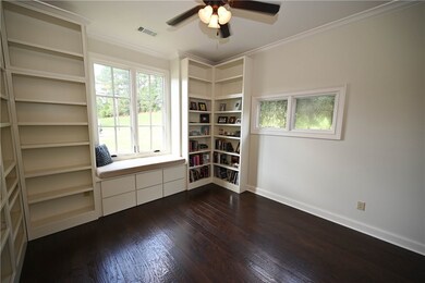 Bedroom 1 with built-in shelving, hardwoods & walk