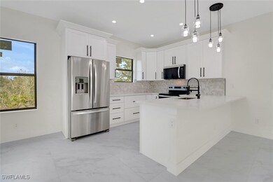 Kitchen featuring decorative backsplash, light cou