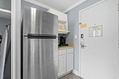 Kitchen featuring crown molding, light countertops