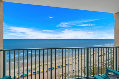 Balcony with view of water and beach