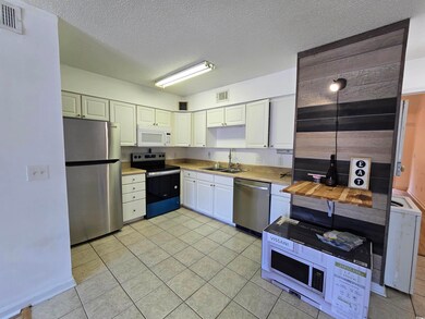 Kitchen featuring light tile patterned flooring, a