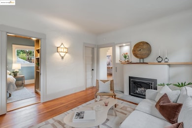 Living room with wood finished floors and a glass covered fireplace