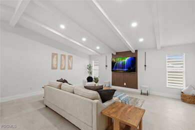Living room with recessed lighting and baseboards