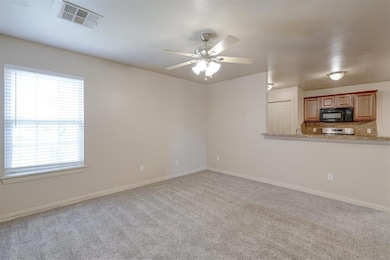 Unfurnished living room featuring plenty of natural light, carpet, and ceiling fan