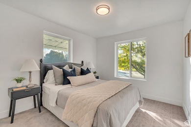 Carpeted bedroom featuring baseboards
