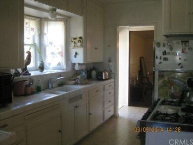 The kitchen window overlooks greenery and there is