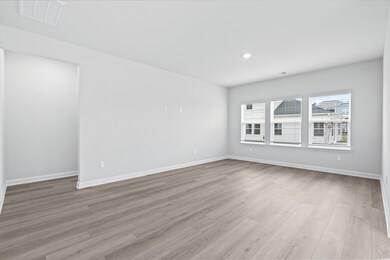 Empty room featuring light hardwood / wood-style f