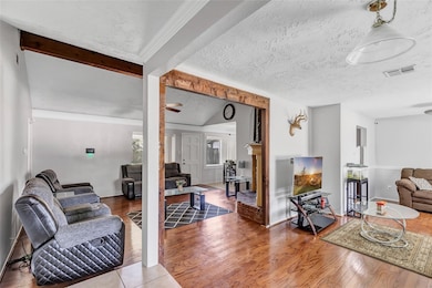 Cozy living area with hardwood floors, neutral wal