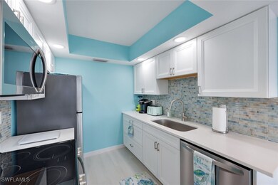 Kitchen with sink, light wood-type flooring, stain