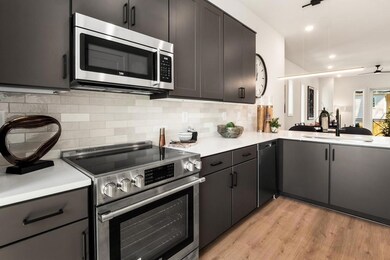 Kitchen featuring sink, tasteful backsplash, light