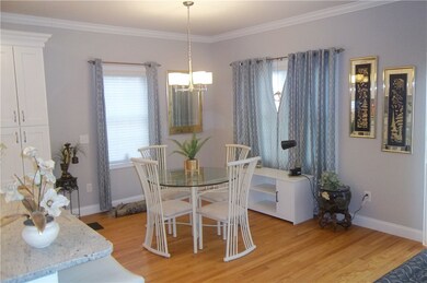 Dining  Area w Hardwood floor and crown molding.