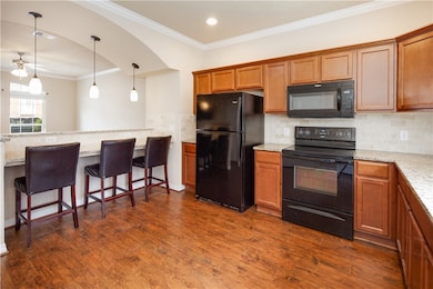 Kitchen featuring dark wood-style floors, decorati