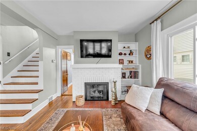 Living room with a fireplace and hardwood / wood-style floors