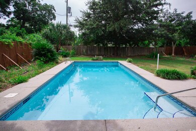 View of swimming pool featuring a yard