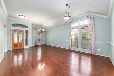 The expansive living room and dining area boast crown molding.
