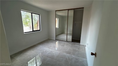 Unfurnished bedroom featuring a closet and a textu